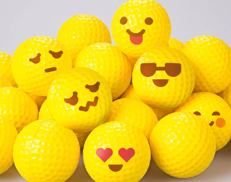 Pelotas de golf con emojis amarillos