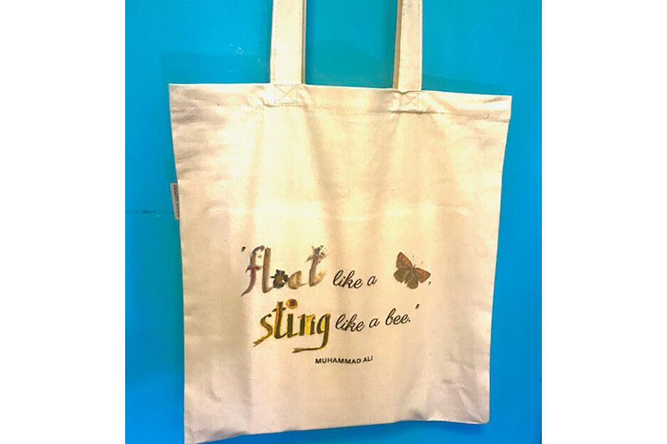 Colorful phrase printed on a tote bag using the Roland DG BT-12 direct-to-garment printer.
