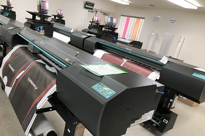 Savi Customs' production room is filled with Roland dye sublimation printers