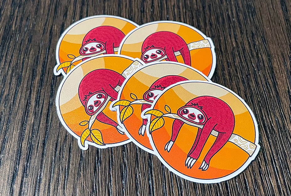 Arteehub produces custom stickers like these colorful sloth stickers using its Roland DG printing equipment.