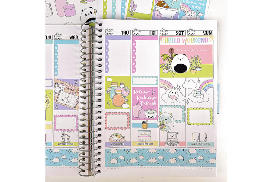 Open spiral-bound planner with multiple pastel stickers produced on a Roland DG TrueVIS VG2 printer/cutter