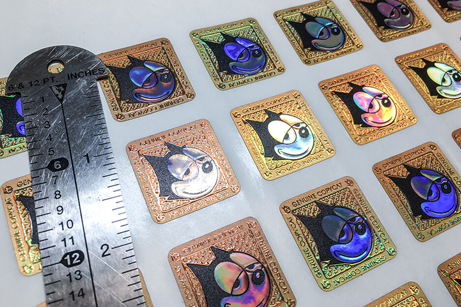 DMS Color produces these small, square colorful cat stickers using its Roland DG VersaUV LEC2-300 UV printer.
