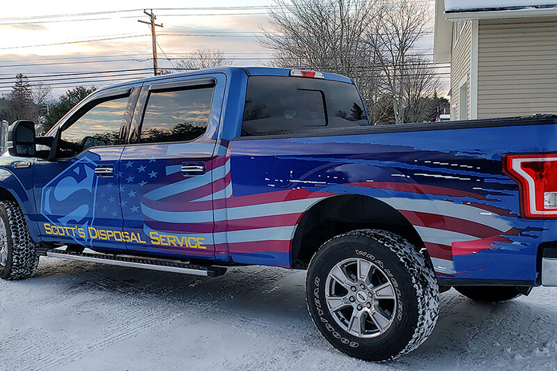 Blue pick-up truck sports patriotic graphics created by East Coast Sign and Design on its Roland DG TrueVIS VG2 digital printer/cutter.