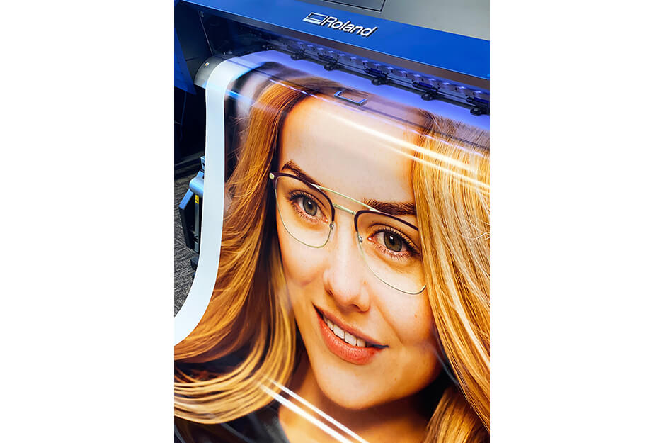Image of woman's face on print coming off of Roland DG printer